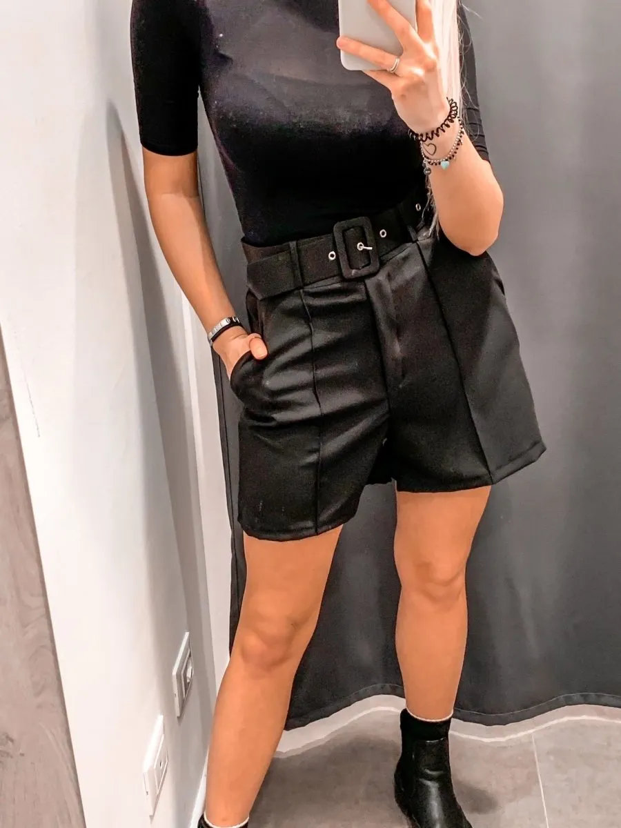 Black stretch shorts with belt.